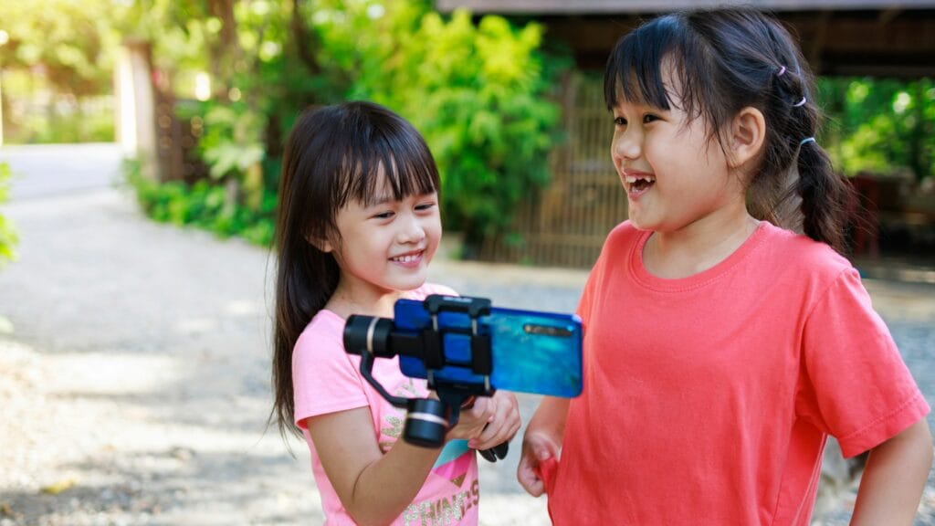 Children as video influencer has fun with online live show for social media.